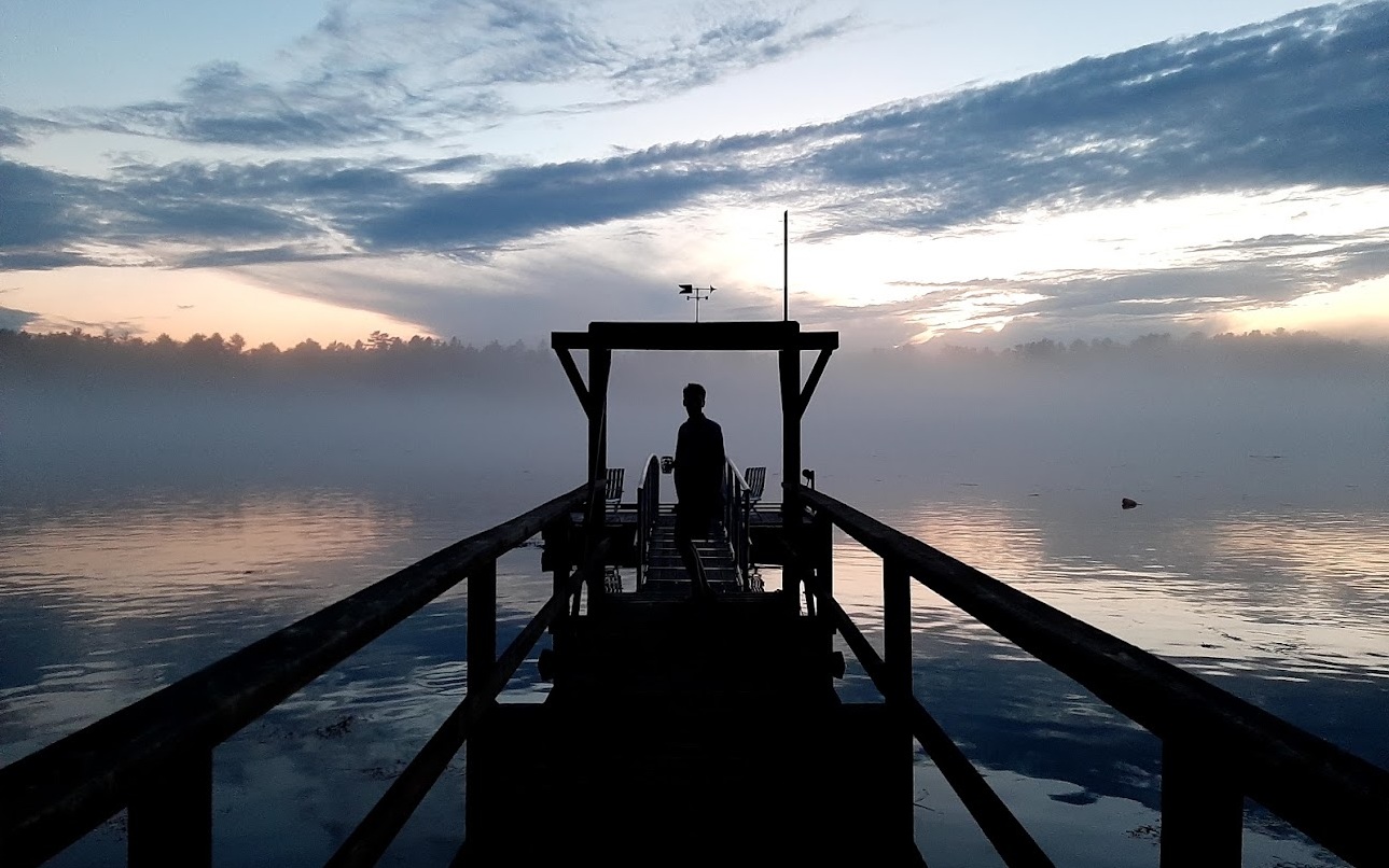 Dylan standing on a dock